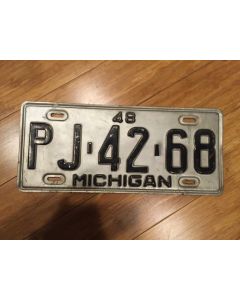 Antique Michigan License Plate 1948.  Black on Silver.  "48" On Top.  "Michigan" on Bottom.  Single plate issued. Condition as Pictured.  PJ-42-68